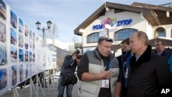FILE - Vladimir Potanin, left, with Russian President Vladimir Putin near Sochi, a resort city in Russia, Feb. 6, 2013.