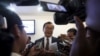 Sam Rainsy (C), president of the Cambodia National Rescue Party (CNRP), speaks to media after a plenary session at the National Assembly in Phnom Penh, March 19, 2015.