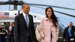 President Barack Obama jokes with his daughter Malia Obama as they walk to board Air Force One from the Marine One helicopter Thursday, April 7, 2016. The White House announced Sunday that Malia will wait a year to begin college at Harvard University. (AP Photo/Jacquelyn Martin)