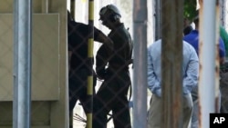 FILE - U.S. Marine Pfc Joseph Scott Pemberton, a suspect in the killing of a transgender Filipino woman, is escorted to his detention inside the compound of the Camp Aguinaldo military headquarters in suburban Quezon city, north of Manila, Philippines.