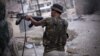 A Free Syrian Army fighter fires his weapon at Syrian Army positions in Aleppo, Syria. Piece by piece, Syria's rebels are slowly starting to expand their arsenal and get their hands on more advanced weapons, September 11, 2012
