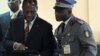 Ivory Coast's internationally recognized President Alassane Ouattara (L) uses an iPad prior to attending African Union talks in Addis Ababa, March 10, 2012. 