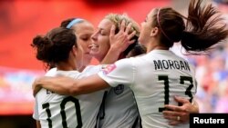 United States forward Abby Wambach (20) is congratulated by midfielder Carli Lloyd (10) and forward Alex Morgan (13)\ after scoring against Nigeria during the first half in a Group D soccer matc, June 16, 2015.