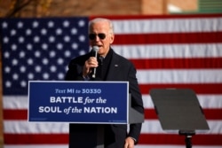 Democratic presidential nominee Joe Biden speaks at a campaign drive-in mobilization event in Flint, Mich., Oct. 31, 2020.