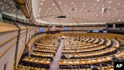 FILE - Members of the European Parliament attend a plenary session at the European Parliament in Brussels, Feb. 25, 2015. In a world of rising populism and fake news, the European Parliament is taking unusual steps to sweep clean hate speech in its own house.