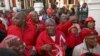 Julius Malema, center, leader of the Economic Freedom Fighters (EFF) party stands outside Parliament after he and party members heckled South African President Jacob Zuma, Cape Town, South Africa, Aug. 21, 2014.