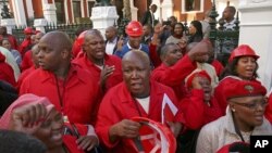Julius Malema, center, leader of the Economic Freedom Fighters (EFF) party stands outside Parliament after he and party members heckled South African President Jacob Zuma, Cape Town, South Africa, Aug. 21, 2014.