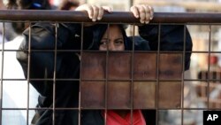 A relative of an inmate awaits news outside the Litoral Penitentiary in Guayaquil, Ecuador, Sept. 29, 2021.