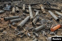 Ammunition shells are strewn around the scene of a fire and explosions at a military ammunition depot in N'Djamena, Chad, June 19, 2024.