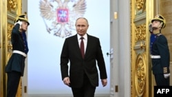 In this pool photograph distributed by Russian state agency Sputnik, Russian president-elect Vladimir Putin walks prior to his inauguration ceremony at the Kremlin in Moscow on May 7, 2024.