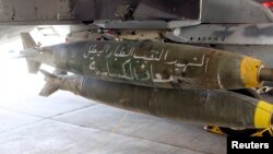 A Royal Jordanian Air Force plane bears bombs that say "the martyr captain and hero pilot Muath al-Kasaesbeh," in preparation for strikes on Islamic State militants in Syrian city of Raqqa, Feb. 5, 2015.