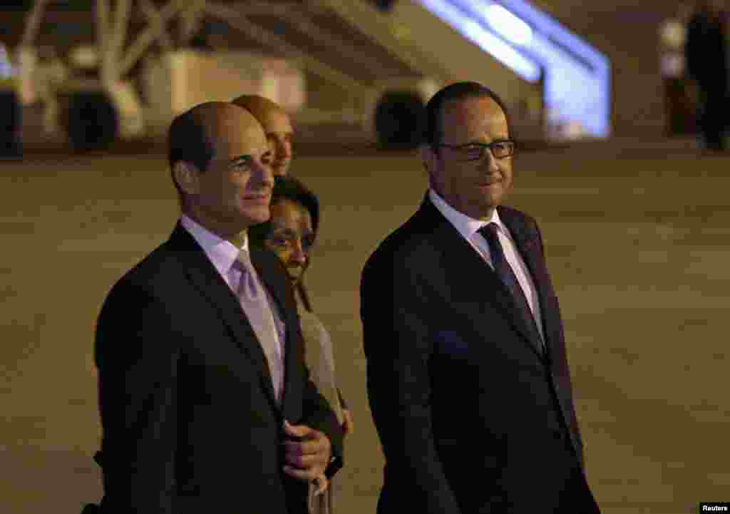 French President Francois Hollande (right) walks next to Cuba's Deputy Foreign Minister Rogelio Sierra at Jose Marti International Airport, Havana, May 10, 2015.