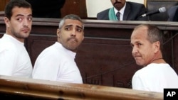 باهر محمد (چپ)، محمد فهمی و پیتر گرست (راست)، سه خبرنگار شبکه الجزیره که در مصر بازداشت شده بودند