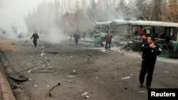 People react to a bus that was hit by an explosion in Kayseri, Turkey, Dec. 17, 2016.