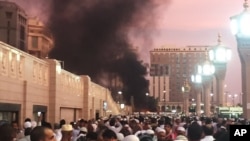 FILE - People stand by an explosion site in Medina, Saudi Arabia, July 4, 2016. (Courtesy of Noor Punasiya via AP)