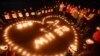 College students light up candles as they pray for passengers of the missing Malaysia Airlines MH370 plane in Yangzhou, Jiangsu province, March 13, 2014.