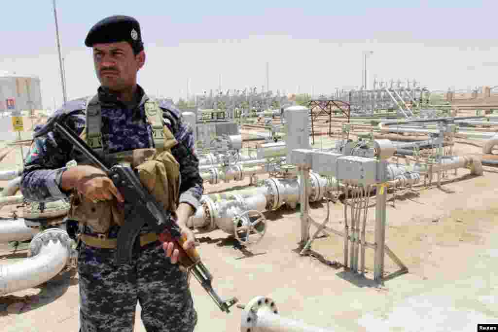 A member from the oil police force stands guard at Zubair oilfield in Basra, southeast of Baghdad, June 18, 2014.