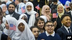 Children from Al-Rahmah school and other guests react after seeing President Barack Obama during his visit to the Islamic Society of Baltimore, Feb. 3, 2016.