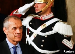 Former senior International Monetary Fund (IMF) official Carlo Cottarelli arrives to talk to the media after a meeting with Italy's President Sergio Mattarella at the Quirinal Palace in Rome, Italy, May 28, 2018.