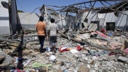 FILE - Debris covers the ground after an airstrike at a detention center in Tajoura, east of Tripoli in Libya, July 3, 2019.