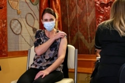 FILE - New Zealand Prime Minister Jacinda Ardern receives the first Pfizer COVID-19 vaccine at the Manurewa Vaccination center in Auckland, New Zealand, June 18, 2021. (Alex Burton/NZ Herald via AP)