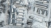 This handout satellite image released by Maxar Technologies shows armored personnel carriers and trucks at Klimovo storage facility, in Russia's Bryansk region, some 13 kilometers north of its border with Ukraine, Jan. 19, 2022.