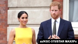 FILE - Prince Harry, Duke of Sussex, and Meghan Markle, Duchess of Sussex, attend the Your Commonwealth Youth Challenge reception at Marlborough House, July 5, 2019..