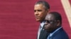 U.S. President Barack Obama and Senegalese President Macky Sall (R) watch a military band play at the airport in Dakar, Senegal, June 28, 2013.