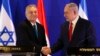 ARCHIVO - El primer ministro húngaro Viktor Orban, a la izquierda, saluda al primer ministro israelí Benjamin Netanyahu en Jerusalén, el 19 de febrero de 2019.