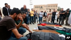 Mourners gather for funeral prayers for fighters killed by warplanes of Field Marshal Khalifa Hifter's forces, Wednesday, April 24, 2019 in Tripoli, Libya.