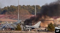Smoke rises from a military base after a plane crash in Albacete, Spain, Jan. 26, 2015.