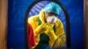 In this Thursday, Oct. 16, 2014 file photo, a healthcare worker dons in protective gear before entering an Ebola treatment center in the west of Freetown, Sierra Leone. (AP Photo/Michael Duff, File)
