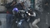 Photographers cower as protesters throw stones towards riot police along Sheikh Rihan street near Tahrir Square in Cairo January 25, 2013.