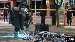 FILE - This handout photo taken by the South Korean Defense Ministry between the night of June 1 and 2, 2024 and released on June 2, 2024 shows South Korean military officers check unidentified objects believed to be North Korean trash from balloons.