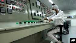 FILE - An Iranian technician works at a uranium conversion facility outside the city of Isfahan, Iran.