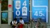 South Korean students sit in front of posters advertising a bank's interest rates in Seoul, South Korea. 