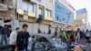 Iraqis gather at the site of a bomb explosion near Baghdad's Tahrir Square, Nov. 16, 2019.