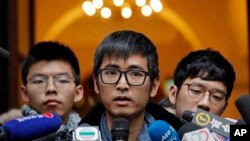 Pro-democracy activist Alex Chow, center, speaks to reporters outside the Court of Final Appeal in Hong Kong, Feb. 6, 2018. 
