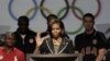 First lady Michelle Obama waves during a news conference in Dallas.