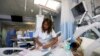 FILE - An Israeli nurse treats a severely wounded Syrian man at the Western Galilee Hospital in the northern city of Nahariya.