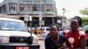 FILE - A woman reacts near the scene of a blast in Kampala, Uganda, Nov. 16, 2021. 