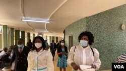 Netsai Marova (C) and Cecilia Chimbiri (R) arrive at Harare Magistrates Court, March 6, 2021, with Charles Kwaramba (L) of Zimbabwe Lawyers for Human Rights. (Columbus Mavhunga/VOA) 