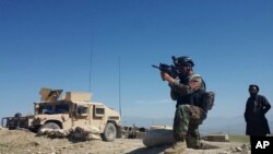 A member of Afghanistan's special forces points his gun as he observes the enemy lines in Achin district of Nangarhar province, in eastern Afghanistan April 14, 2017.