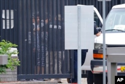 Authorities move immigrant children into a van from a youth holding facility to an undisclosed location, July 10, 2018, in Phoenix.