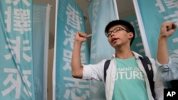 Student protest leader Joshua Wong shouts slogans outside a magistrate's court in Hong Kong, July 21, 2016.