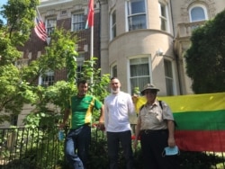 Roman Vasiliuk, center, Aleksas Radzius, right, and Vytas Pakalniskis came from Virginia and Maryland to take part in the demonstration in support of protesters in Belarus held in Washington, Aug. 23, 2020. (Natalie Liu/VOA)