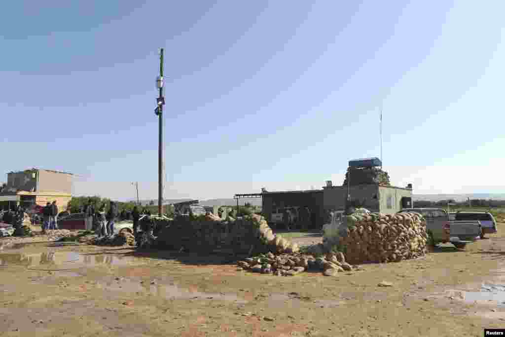 The scene at a military base 50 km outside Benghazi, after a suicide bomber detonated a truck packed with explosives at an army checkpoint, Barsis, Libya, Dec. 22, 2013. 