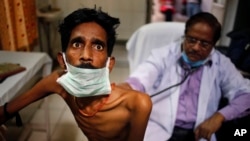 FILE - A doctor examines a tuberculosis patient in a government TB hospital in Allahabad, India, March 24, 2014. UNITAID has just launched a new multi-million dollar initiative to finance new treatments that can prevent the onset of full-blown tuberculosis.