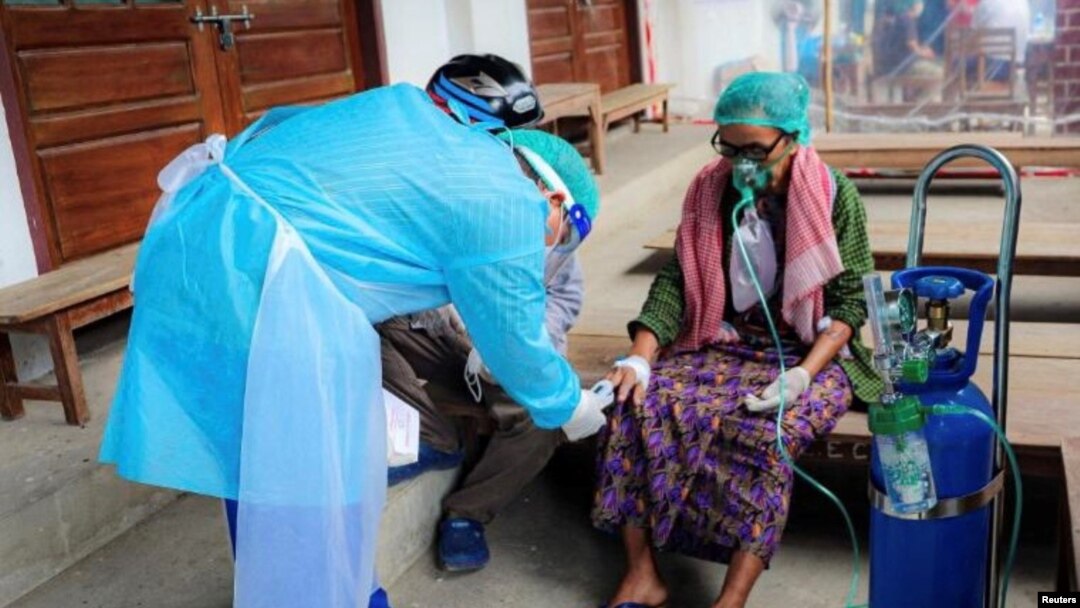 Volunteer checks the blood oxygen level of a coronavirus disease (COVID-19) patient in the town of Kale, Sagaing Region, Myanmar, July 5, 2021.