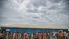 FILE - Rohingya Muslims, who crossed over from Myanmar into Bangladesh, wait in queues to receive aid at Kutupalong refugee camp in Ukhiya, Bangladesh.